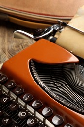 Photo of Vintage typewriter with sheet of parchment paper on table, closeup