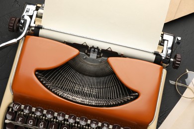 Photo of Flat lay composition with vintage typewriter on black background