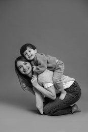 Photo of Happy mother with her little son, black and white effect