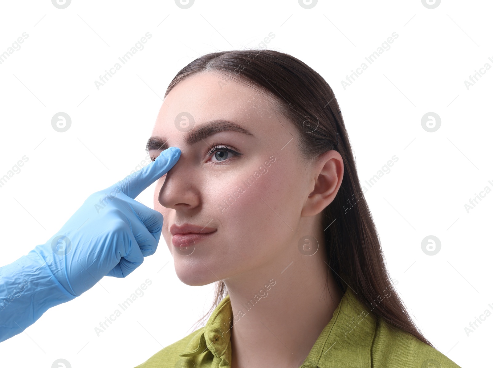 Photo of Doctor checking patient's nose before plastic surgery operation on white background, closeup