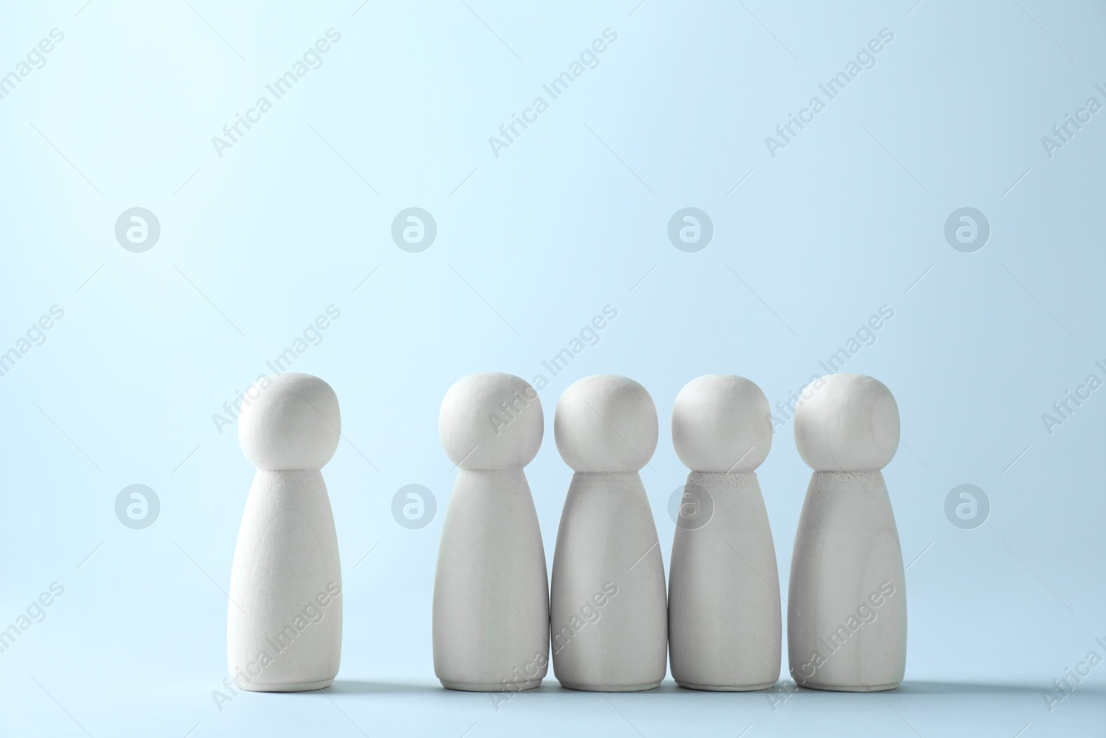 Photo of Human resources concept. Many wooden figures on light background, closeup. Space for text