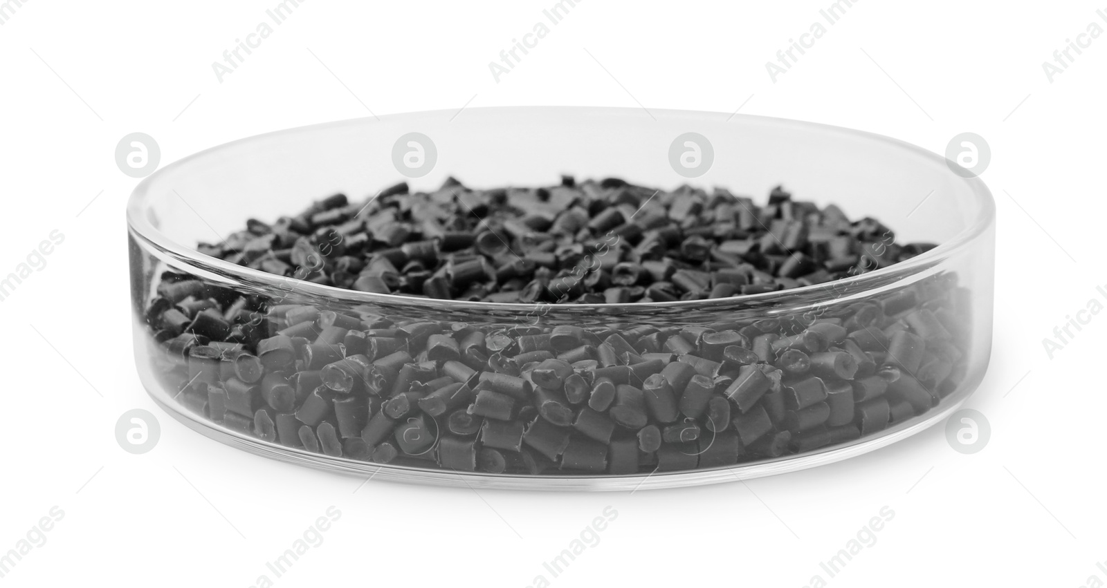 Photo of Black plastic granules in petri dish isolated on white