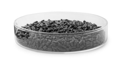 Photo of Black plastic granules in petri dish isolated on white