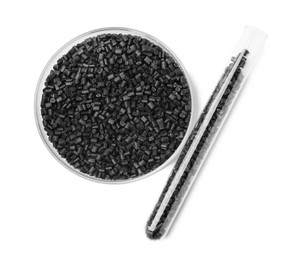 Photo of Black plastic granules in petri dish and test tube isolated on white, top view