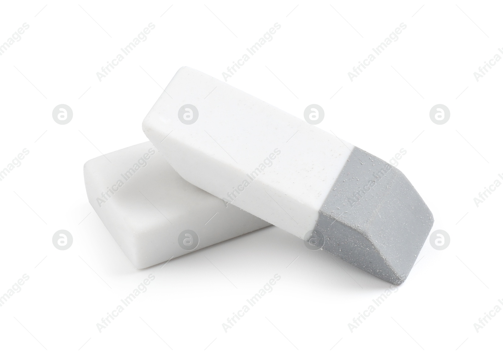 Photo of Two new erasers isolated on white. School stationery