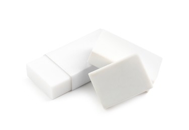 Photo of Different new erasers isolated on white. School stationery