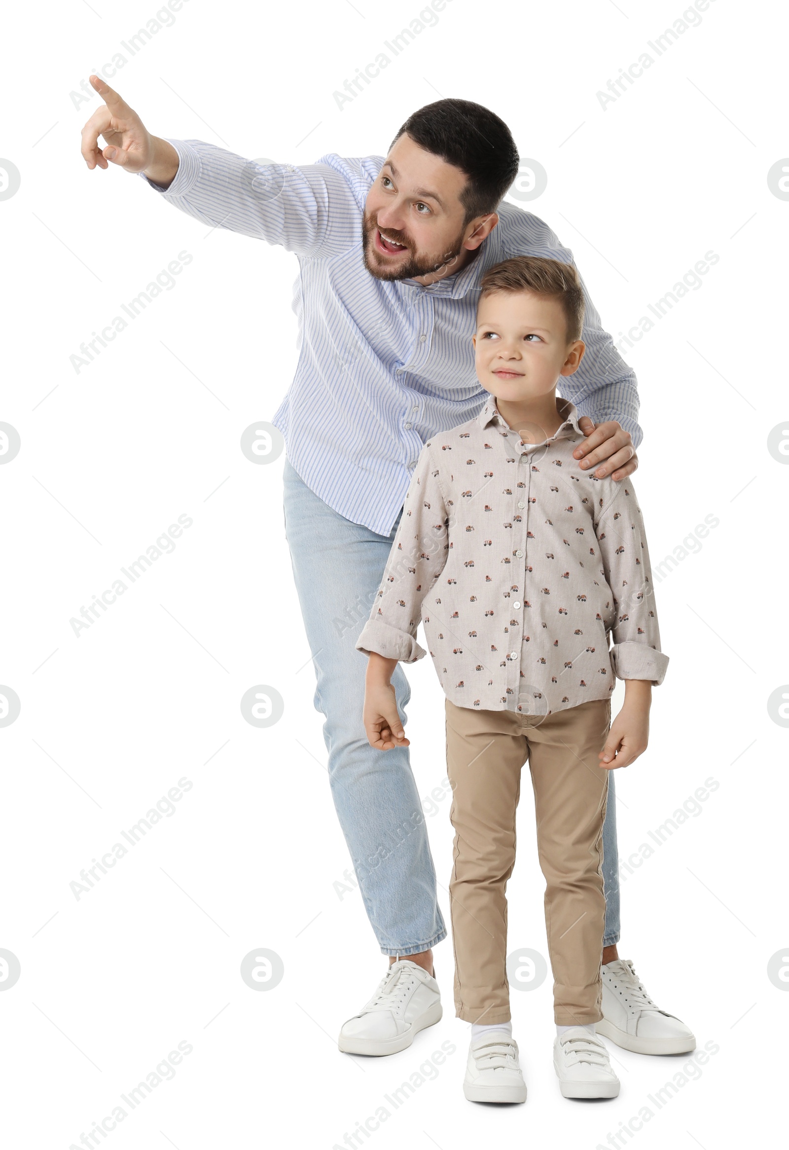 Photo of Happy father with his cute little son looking at something on white background