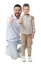 Photo of Happy father with his cute little son showing thumbs up on white background