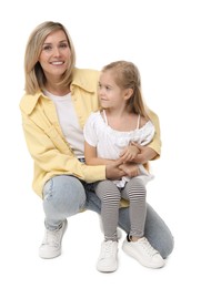 Happy mother and her cute little daughter on white background