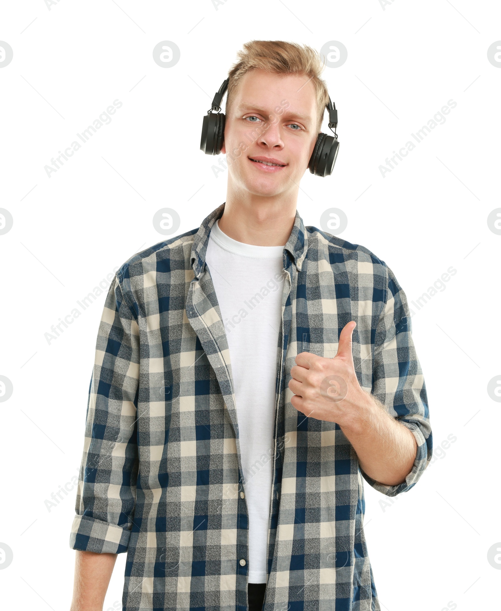 Photo of Happy man in headphones showing thumbs up on white background. Like gesture