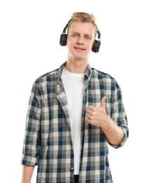 Photo of Happy man in headphones showing thumbs up on white background. Like gesture