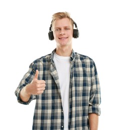 Photo of Happy man in headphones showing thumbs up on white background. Like gesture