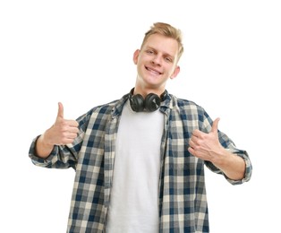 Happy man with headphones showing thumbs up on white background. Like gesture