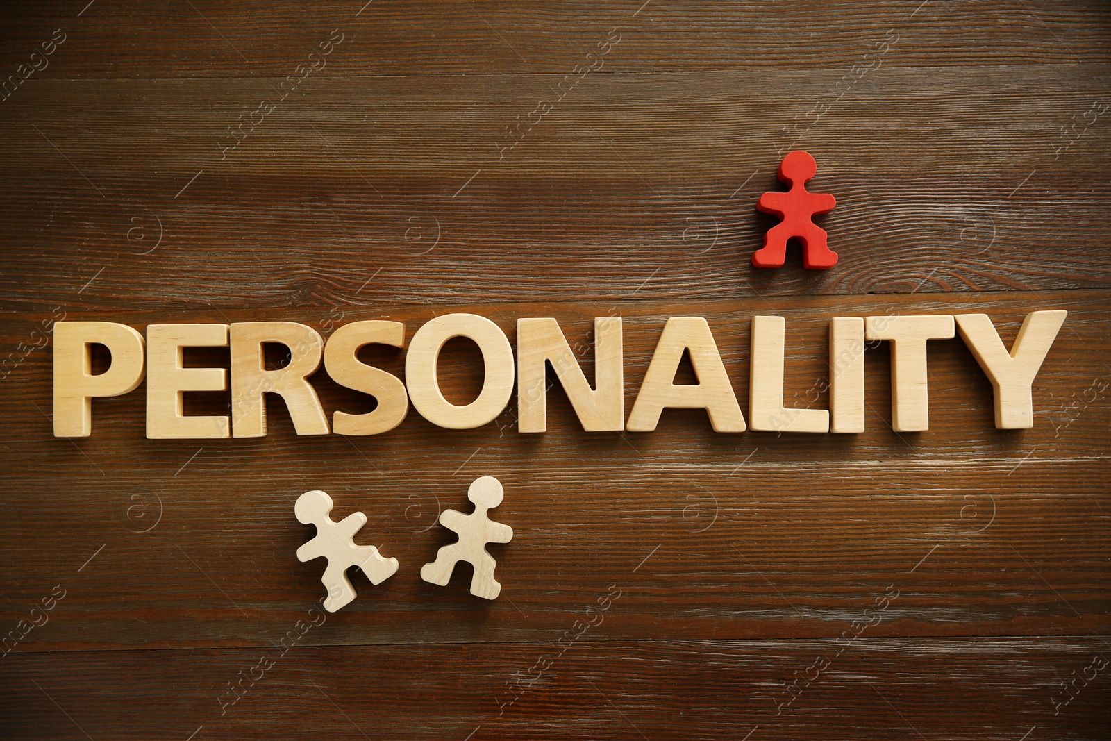 Photo of Word Personality made of letters and human figures on wooden table, top view