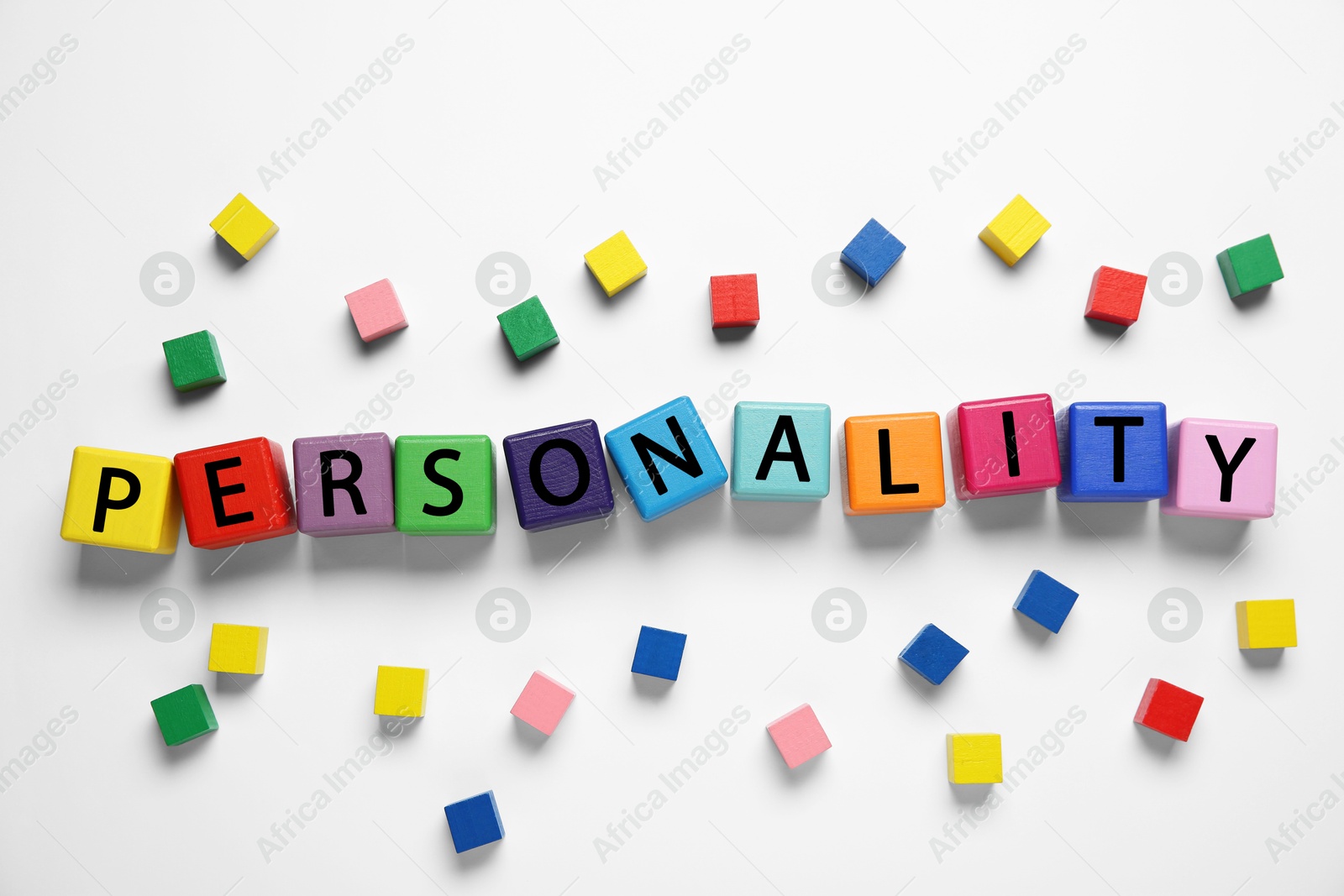 Photo of Word Personality made of colorful cubes with letters on white background, top view