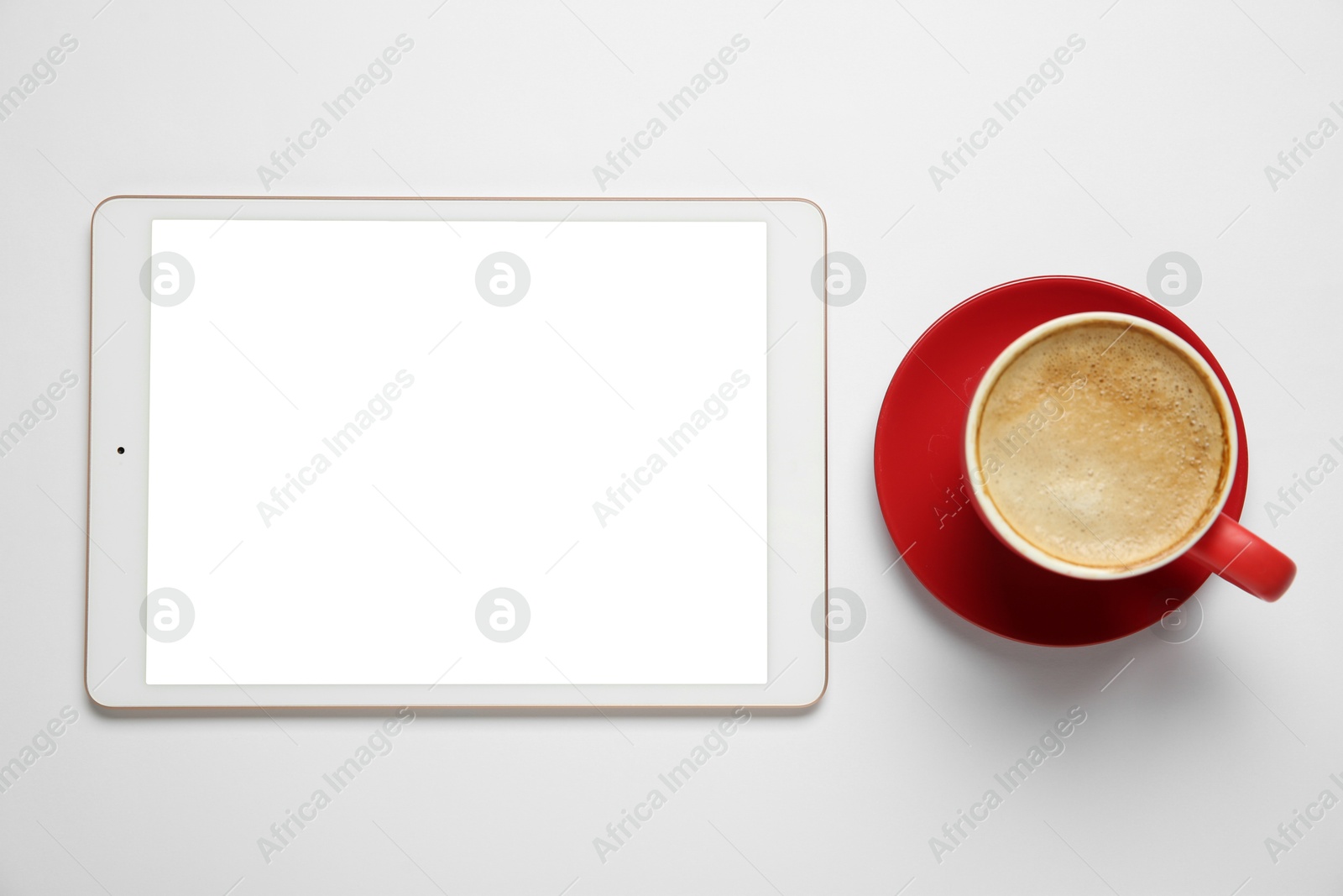 Photo of Tablet with blank screen and coffee on white background, top view. Space for design