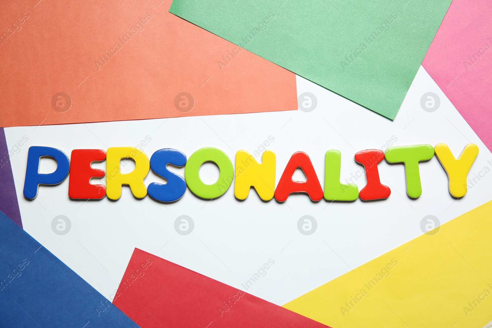 Photo of Word Personality made of letters on color background, top view