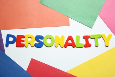 Photo of Word Personality made of letters on color background, top view