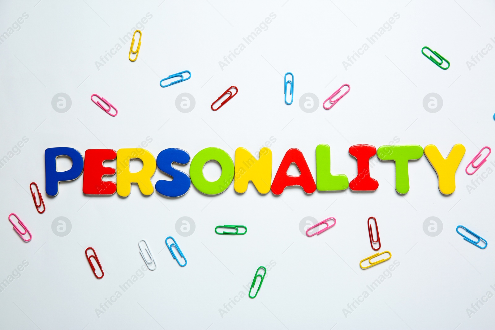 Photo of Word Personality made of colorful letters and paper clips on white background, top view