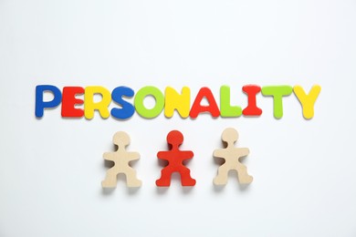 Photo of Word Personality made of colorful letters and human figures on white background, top view