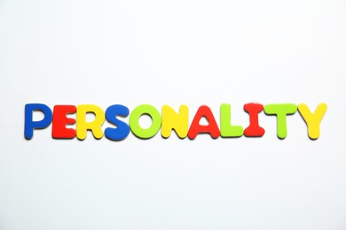 Photo of Word Personality made of colorful letters on white background, top view