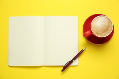 Photo of Blank notebook, coffee and pen on yellow background, flat lay. Space for text