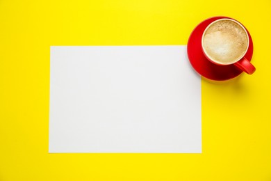 Photo of Blank paper and coffee on yellow background, top view. Space for text