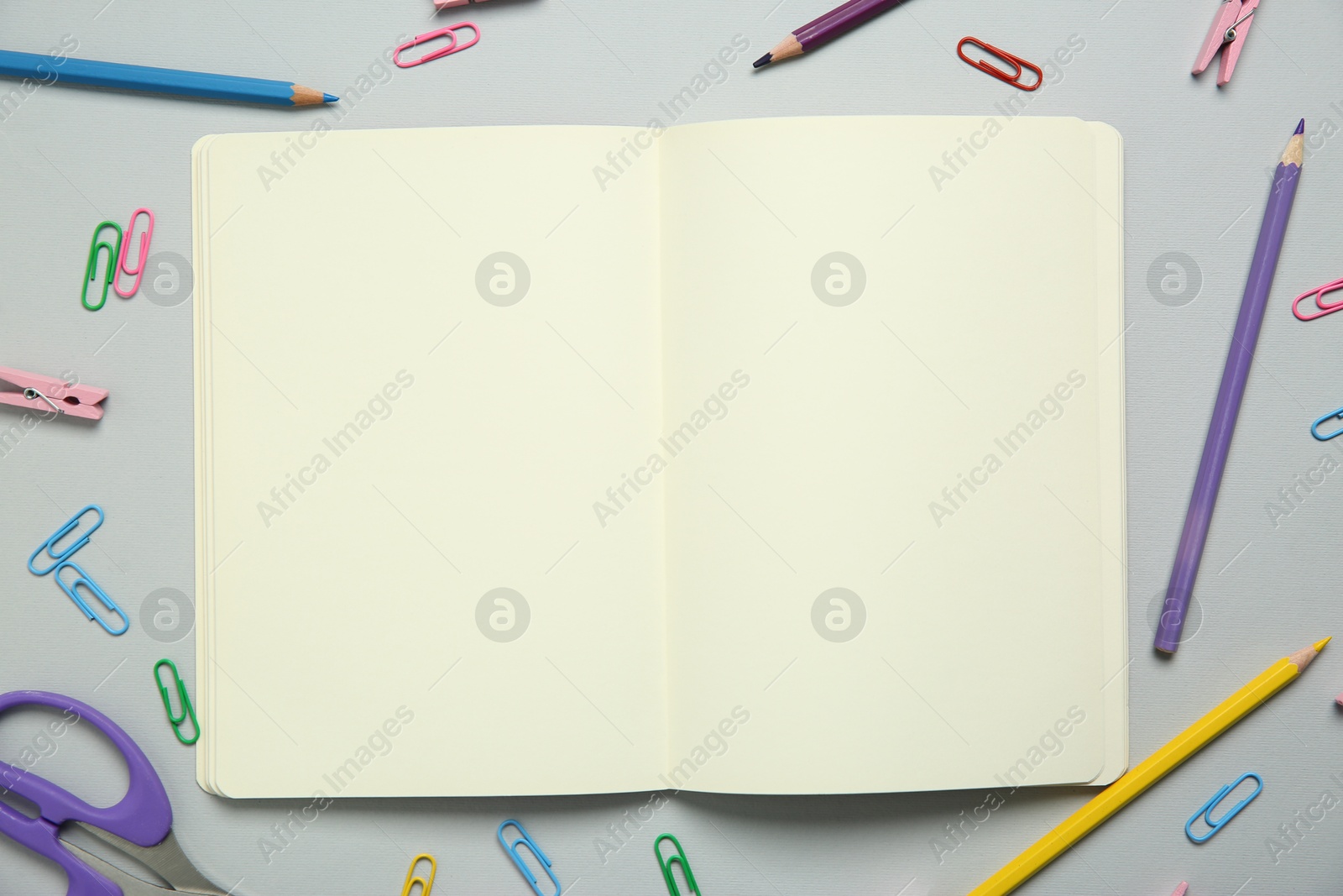 Photo of Blank notebook and stationery on light grey background, flat lay. Space for text