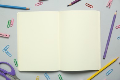 Photo of Blank notebook and stationery on light grey background, flat lay. Space for text