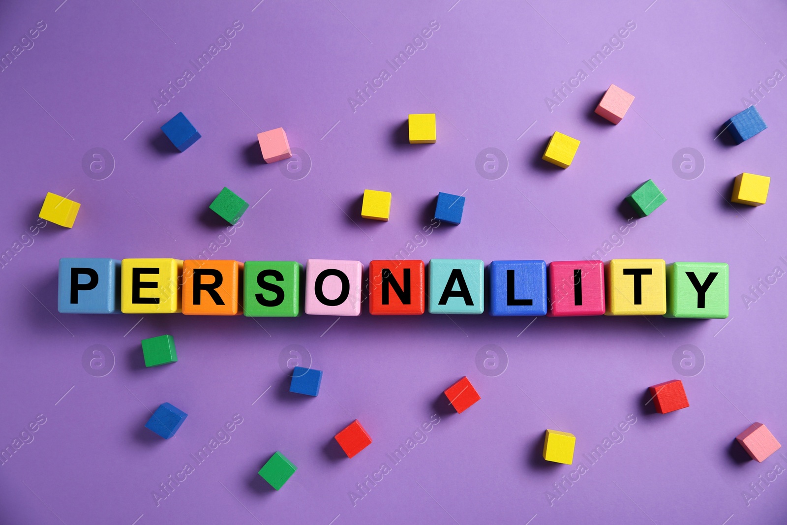 Photo of Word Personality made of colorful cubes with letters on purple background, top view