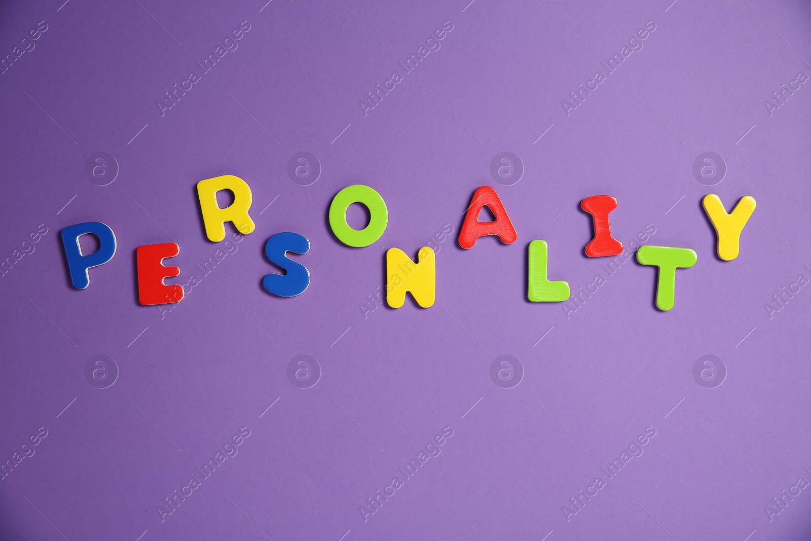 Photo of Word Personality made of colorful letters on purple background, top view