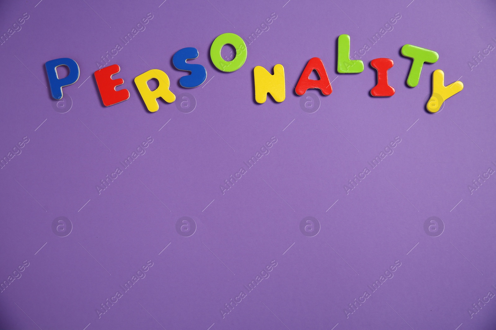 Photo of Word Personality made of colorful letters on purple background, top view. Space for text