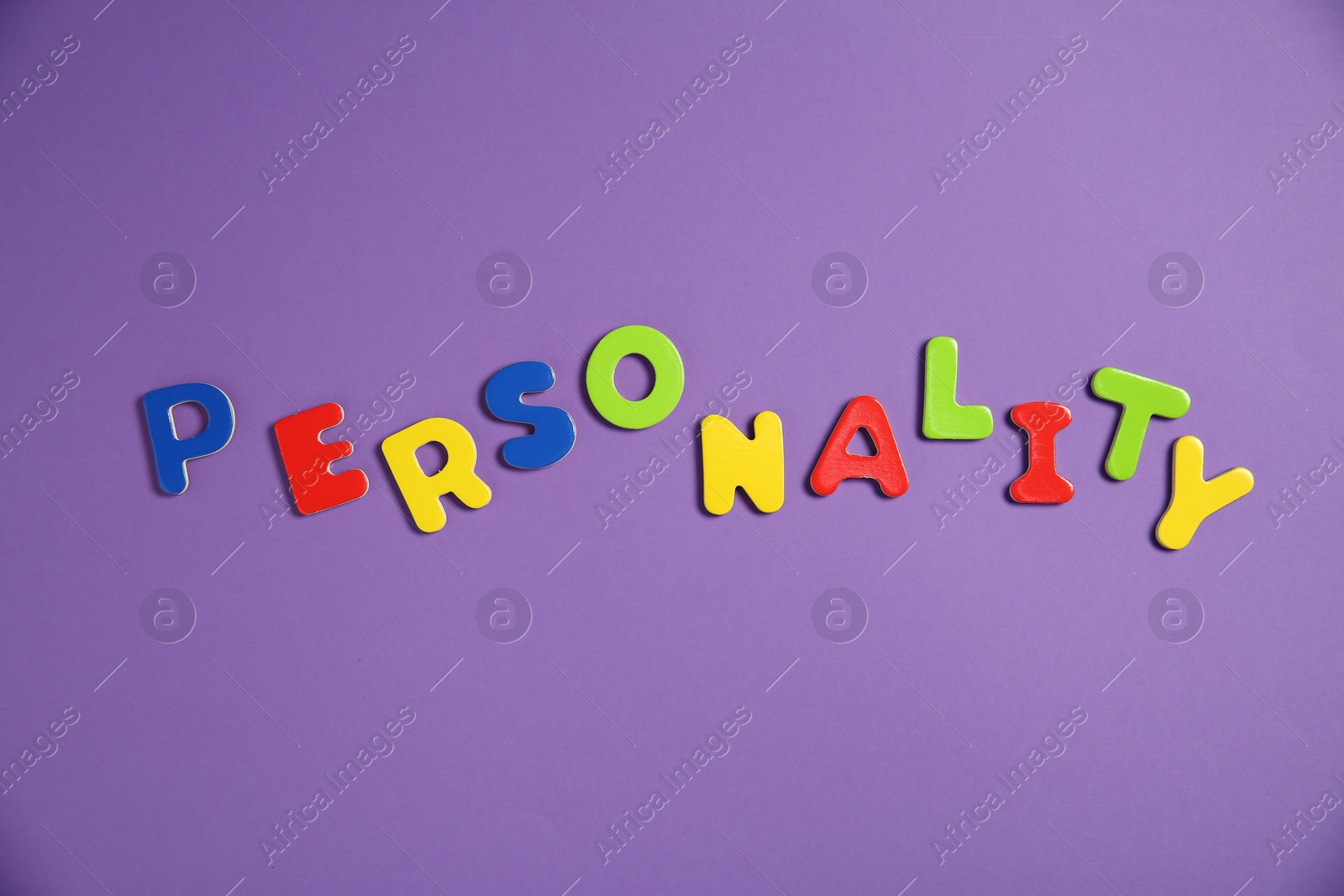 Photo of Word Personality made of colorful letters on purple background, top view