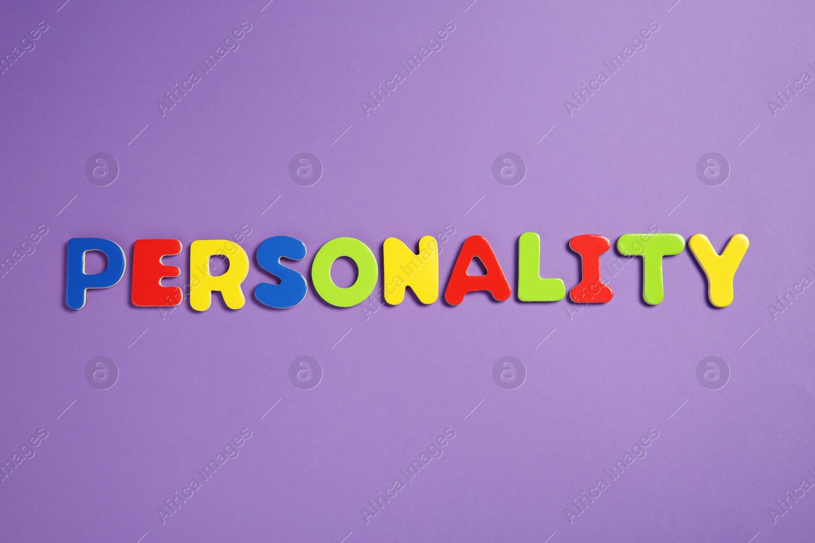 Photo of Word Personality made of colorful letters on purple background, top view