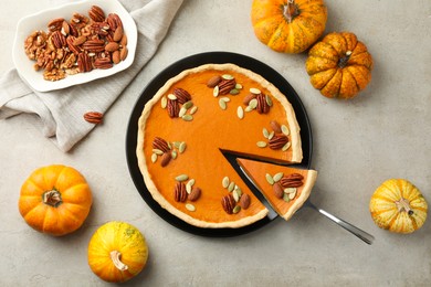 Photo of Tasty homemade pumpkin pie served on grey table, top view