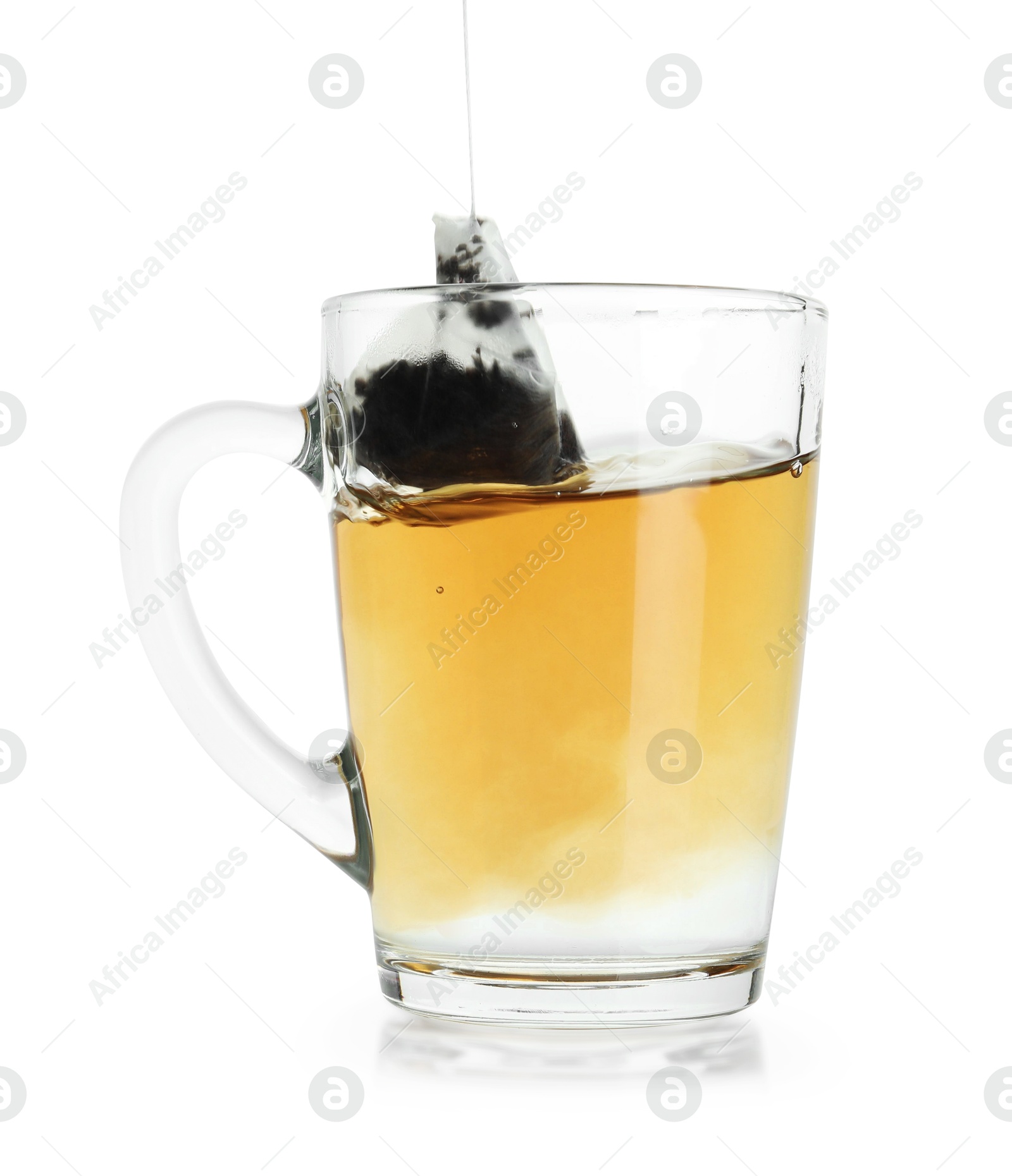 Photo of Brewing aromatic tea. Cup with teabag isolated on white