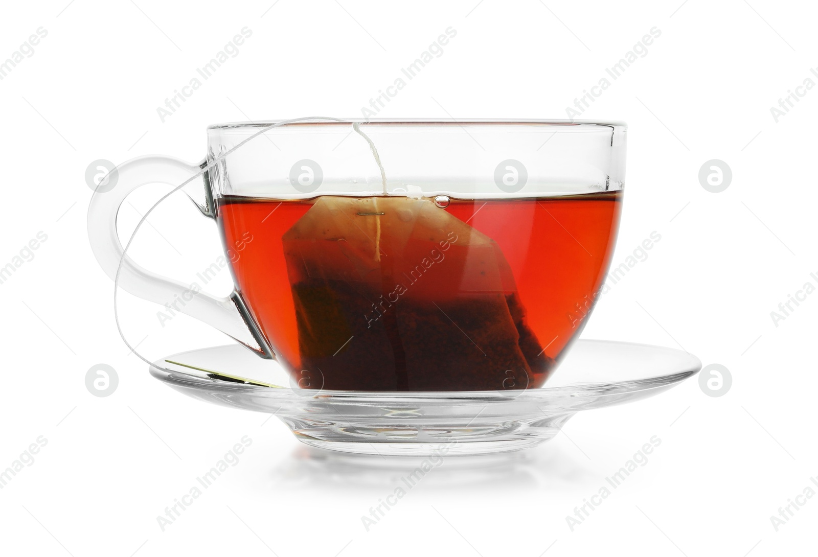 Photo of Brewing aromatic tea. Cup with teabag isolated on white