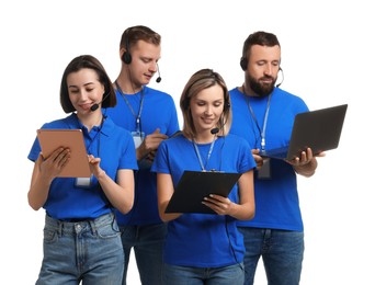 Photo of Technical support call center. Team of friendly operators working on white background