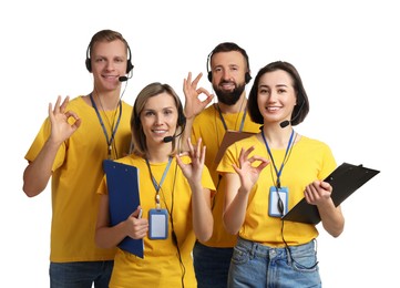 Photo of Technical support call center. Team of friendly operators showing ok gesture on white background