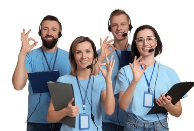 Photo of Technical support call center. Team of friendly operators showing ok gesture on white background