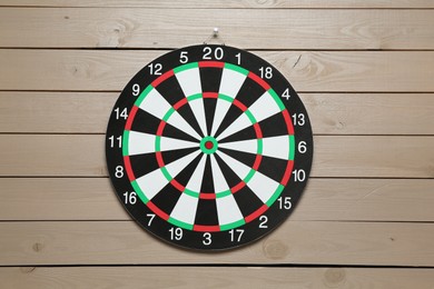 Photo of One dart board hanging on wooden background