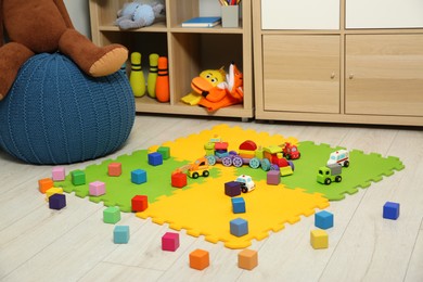 Photo of Colorful cubes and other toys in kid's room