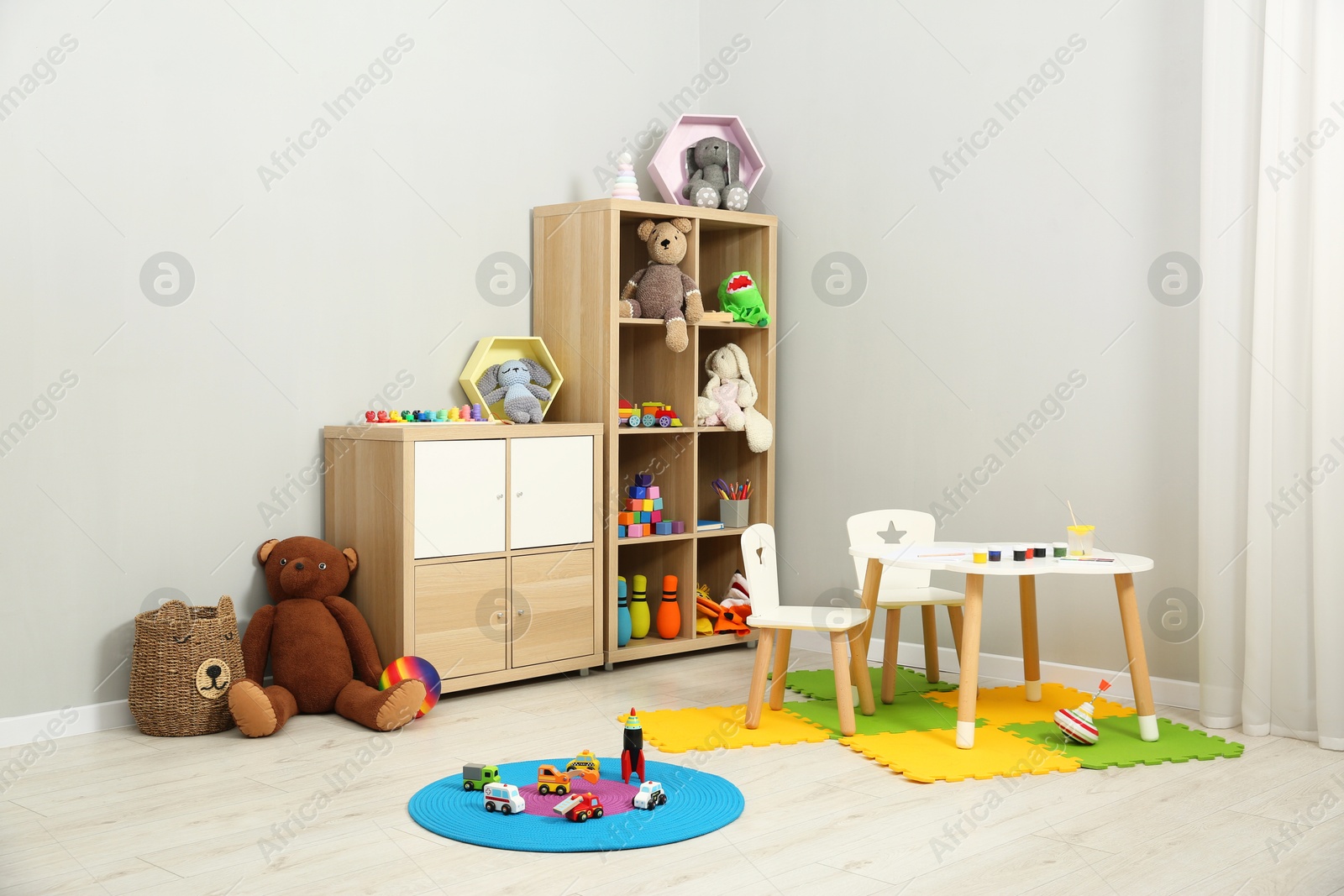 Photo of Beautiful kid's room interior with toys and stylish furniture