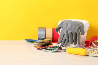 Photo of Different painter's tools on white wooden table, space for text. Decorating and design