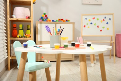 Photo of Table with paints and other stationery in child's room