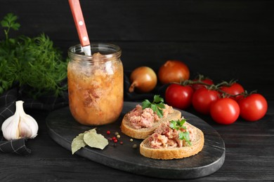 Photo of Sandwiches with canned meat served on wooden table