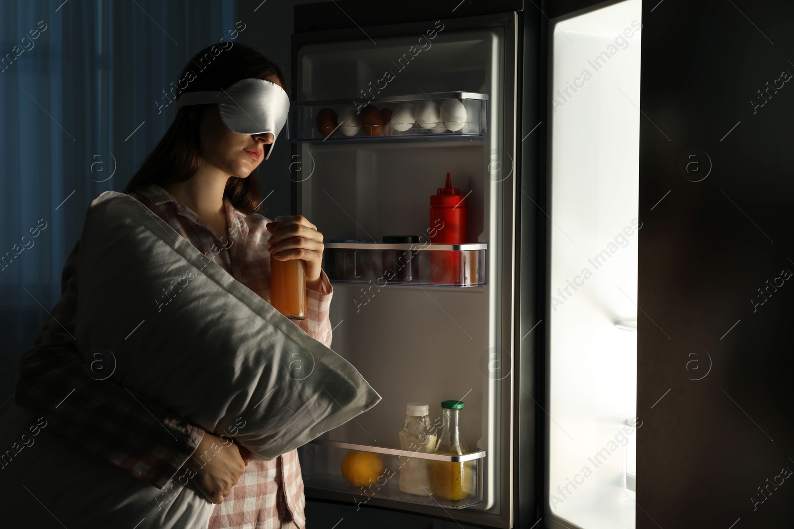 Photo of Young woman suffering from sleepwalking near fridge at home