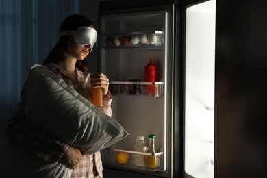 Photo of Young woman suffering from sleepwalking near fridge at home