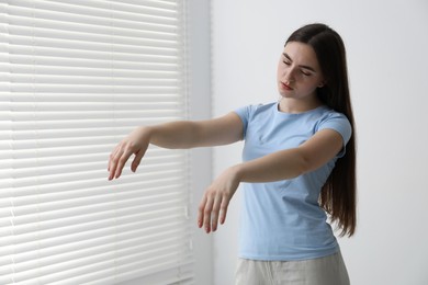 Photo of Young woman suffering from sleepwalking at home