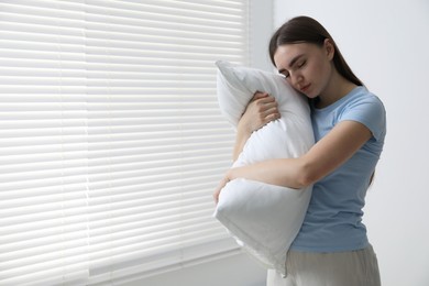 Photo of Young woman suffering from sleepwalking at home, space for text